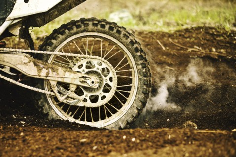 Dirt bike tire smoking in dirt
