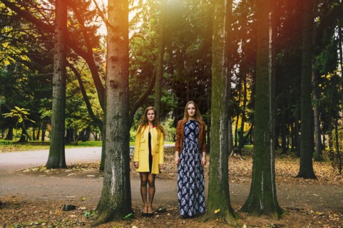 Caucasian women standing between trees in park
