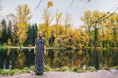 Caucasian woman smiling near pond in park