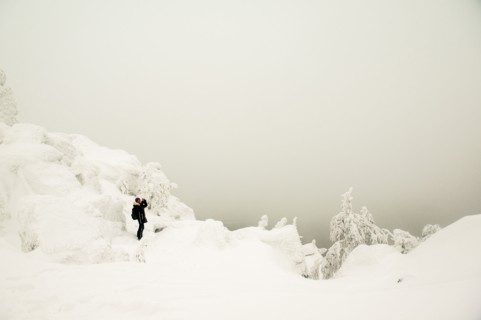 Hiker walking in snowy forest
