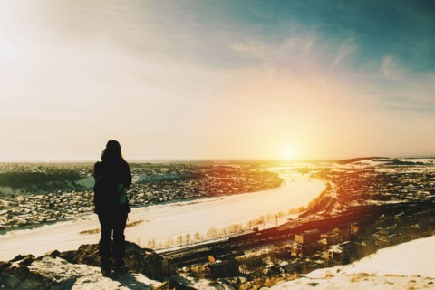 Hiker admiring cityscape view from mountain