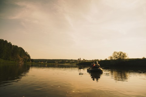 Caucasian family paddling boat on river