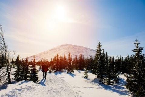 Man hiking on mountain in winter