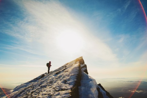 Man hiking on mountain in winter