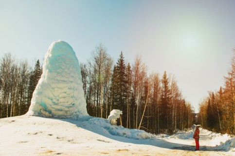 Woman admiring pile of snow in winter