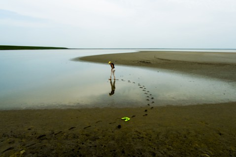 Footprints of woman wading at beach