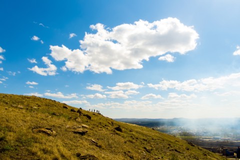 Clouds over Caucasian friends on distant hill