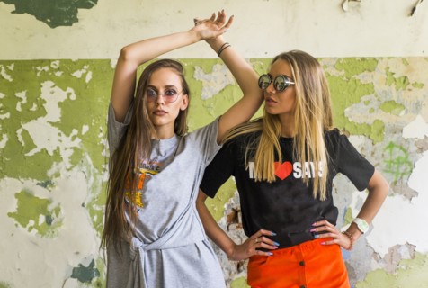 Women standing near dilapidated wall