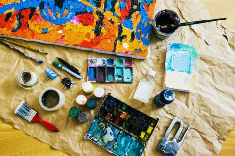 Canvas and painting tools on brown paper