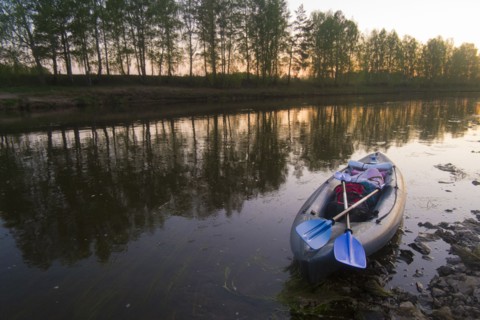Oars on empty inflatable raft on river