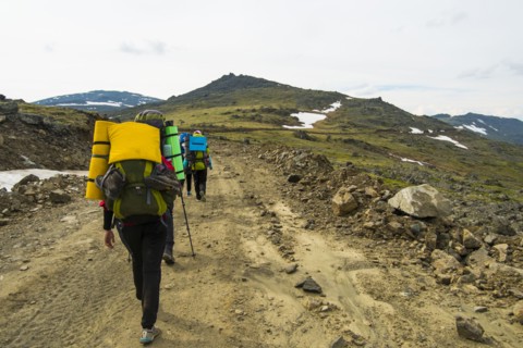 Hikers walking on mountain path in winter