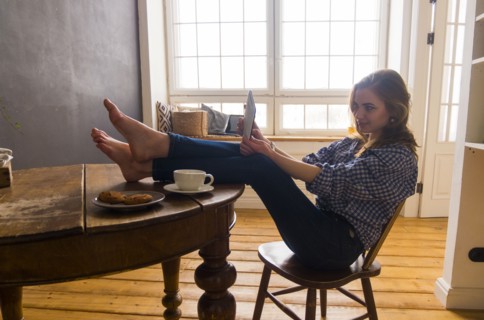 Caucasian woman posing for selfie with digital tablet