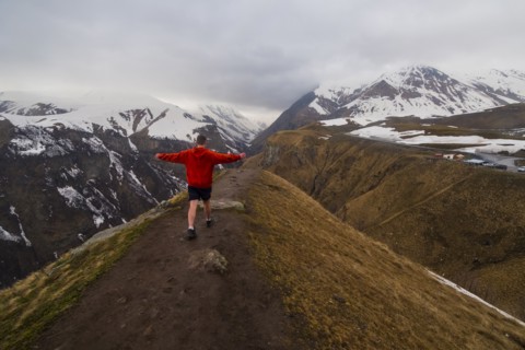 Caucasian man hiking on snowy Mountain