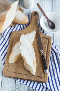 Bread with butter on cutting board