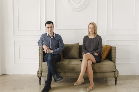 Portrait of Middle Eastern couple sitting on sofa