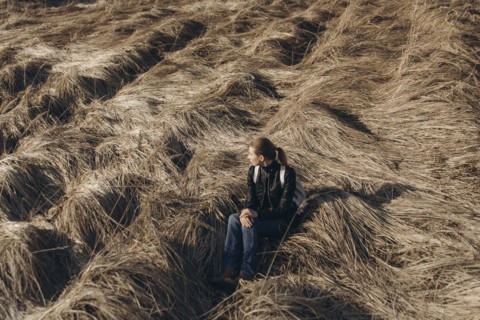 Middle Eastern woman resting in tall grass