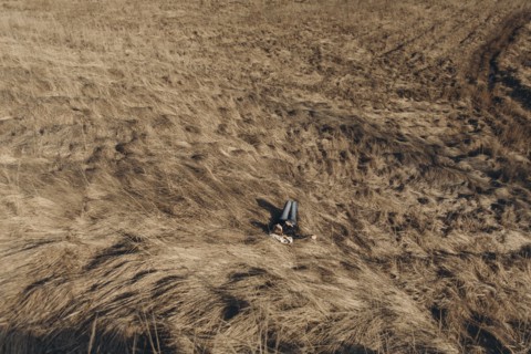 Middle Eastern woman resting on hill