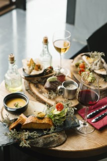 Variety of meat and fish on table with wine