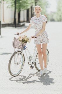 Portrait of Middle Eastern woman standing near bicycle