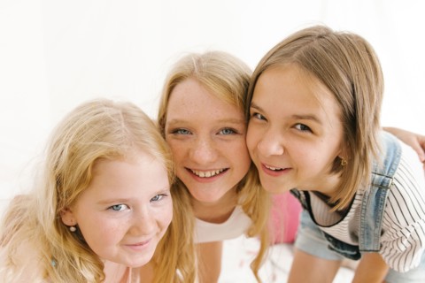 Portrait of smiling Middle Eastern sisters cheek to cheek