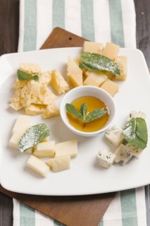 Variety of cheeses on plate with sauce