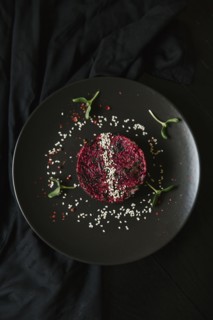 Sesame seeds and garnish on red food on plate