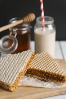 Dessert on cutting board with milk and honey