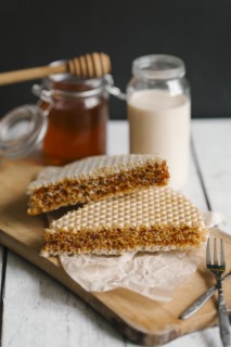 Dessert on cutting board with milk and honey