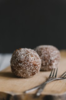 Chocolate balls with forks on cutting board