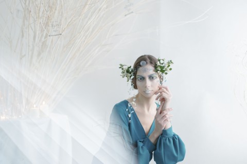 Ethereal woman wearing blue dress and makeup