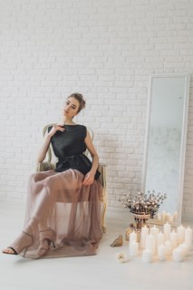 Portrait of glamorous Middle Eastern woman sitting near candles