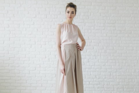 Portrait of glamorous Middle Eastern woman standing near wall