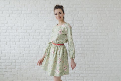 Portrait of glamorous Middle Eastern woman standing near wall