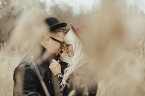 Middle Eastern couple rubbing noses in field