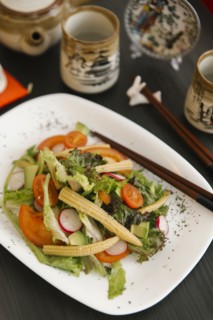 Chopsticks on plate of salad