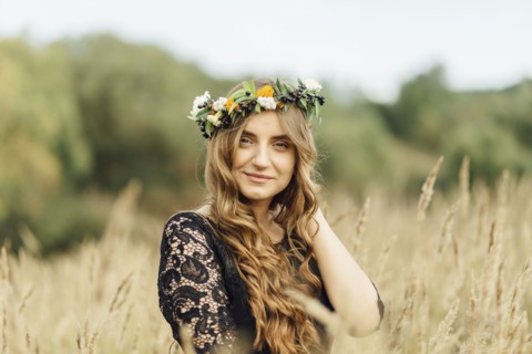 Middle Eastern woman wearing flower crown in field