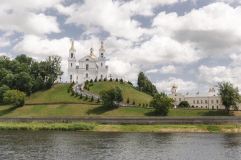 Scenic view of castle on hill near river