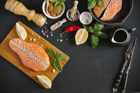 Raw salmon on cutting board with ingredients
