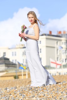 Woman holding bouquet on beach