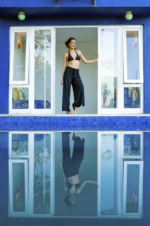 Mixed race woman reflected in swimming pool