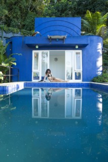Mixed race woman reflected in swimming pool