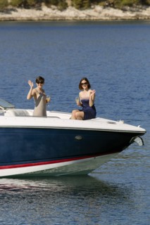 Women waving from boat in ocean
