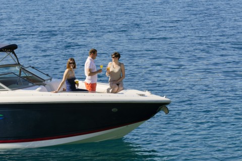 Friends relaxing on boat in ocean