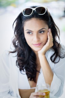Hispanic woman drinking cocktail outdoors