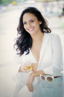 Hispanic woman drinking cocktail outdoors