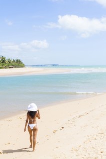 Mixed race woman walking on beach