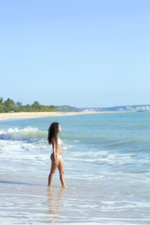 Mixed race woman walking on beach