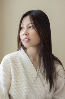 Woman wearing white robe looking away