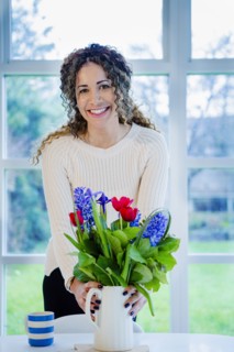 Woman holding vase with flowers