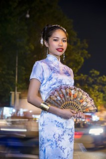 Portrait of Asian woman wearing traditional clothing holding fan